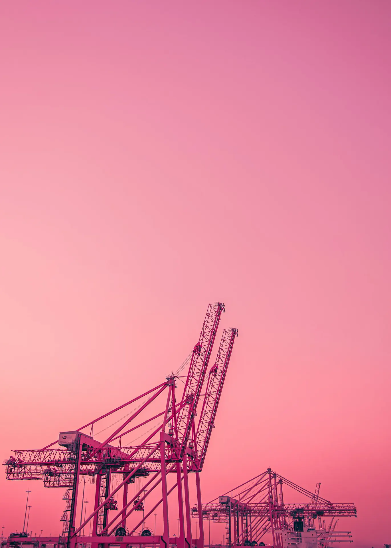 Port terminal cranes at dusk