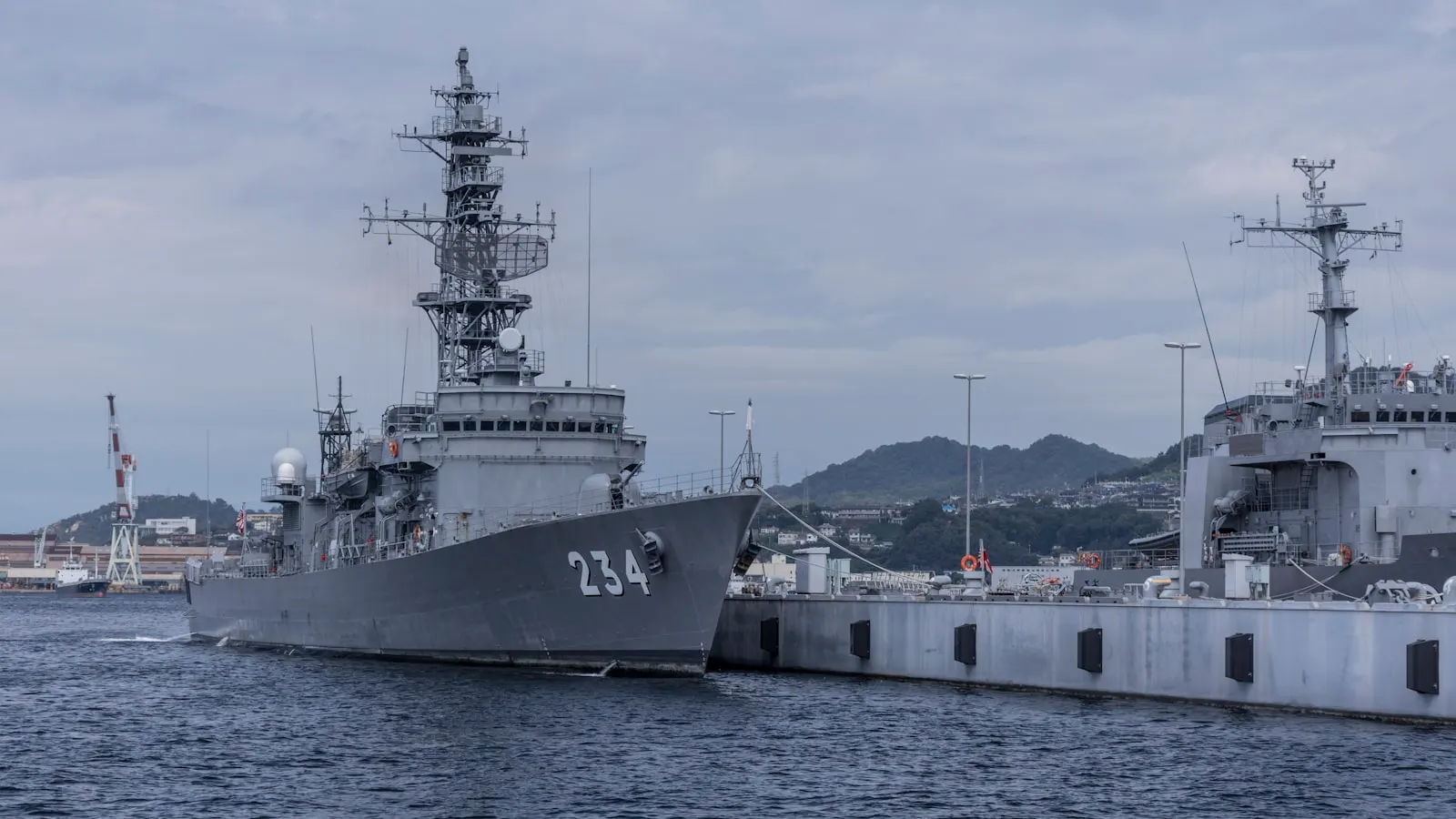 Grey naval warship in harbour