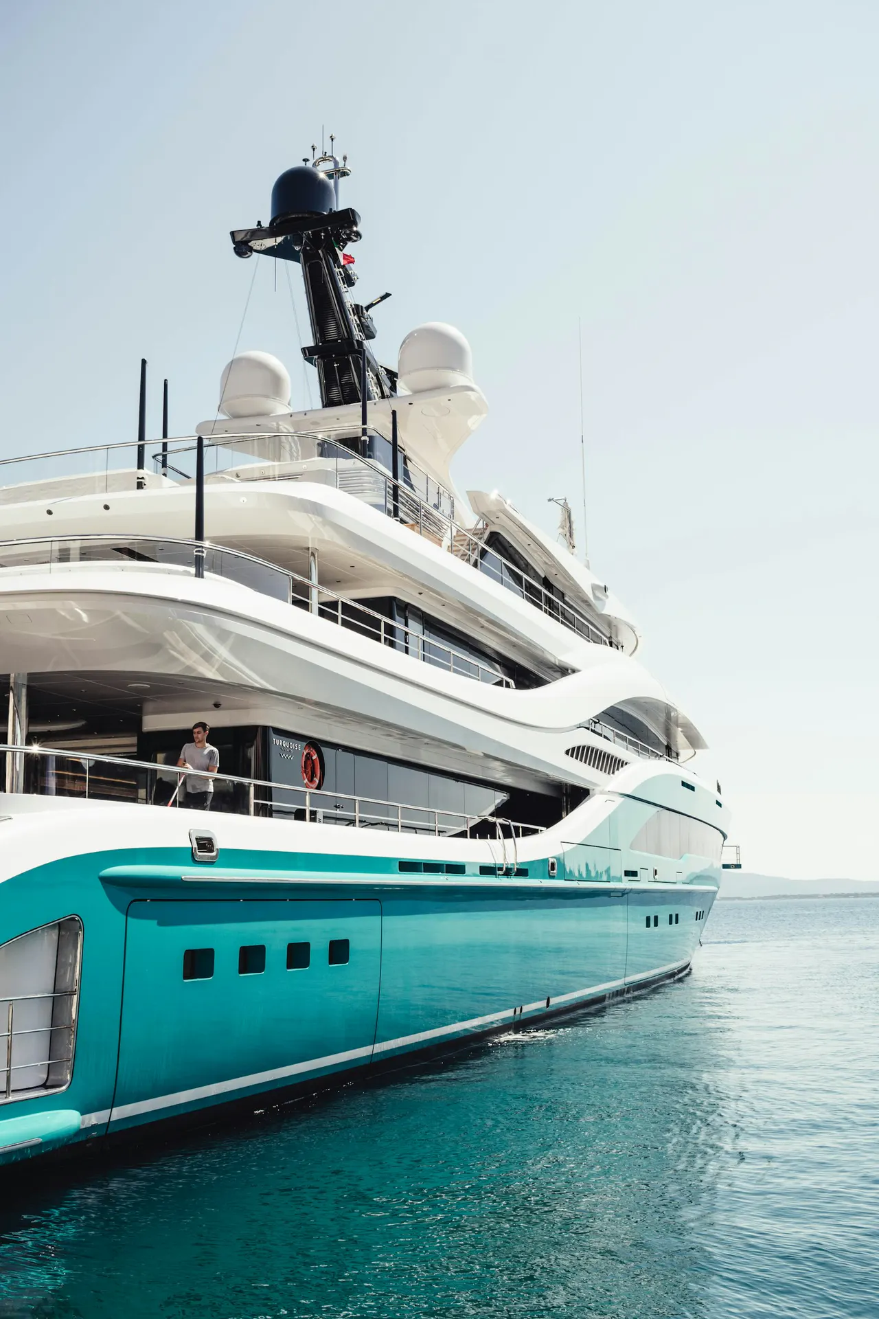 A large superyacht anchored off an Italian coastal town