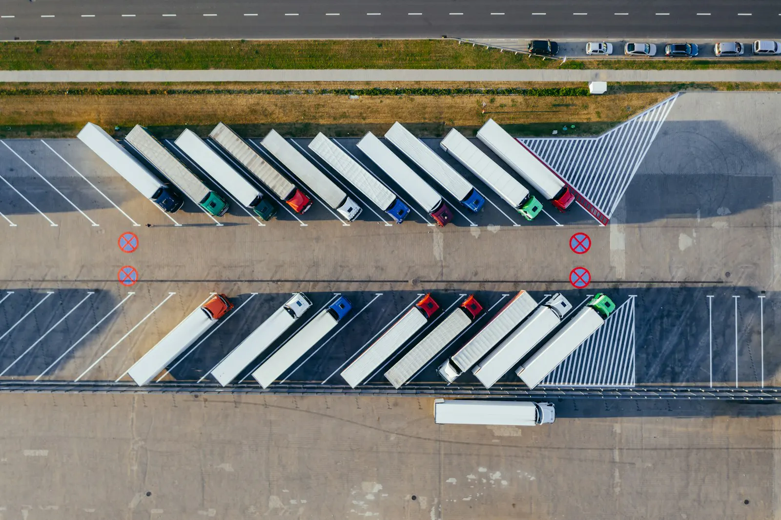 A logistics warehouse with trucks loading at multiple bays