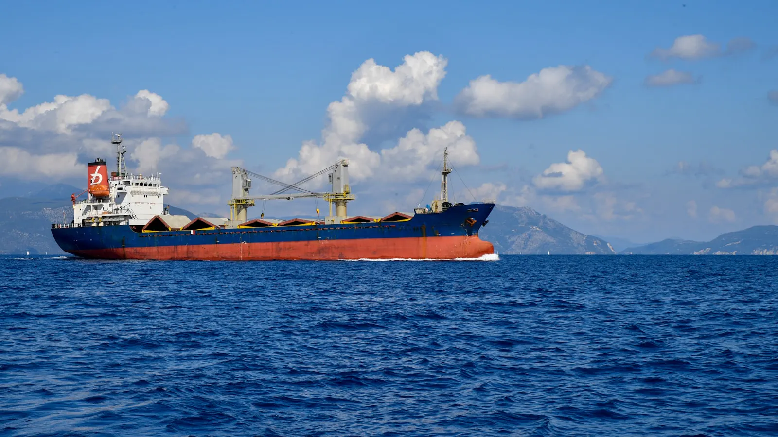 A small general cargo ship at sea