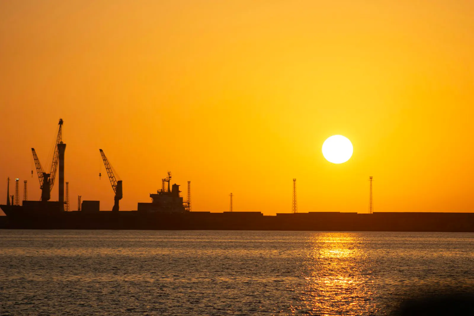 A container ship transiting open water at dusk